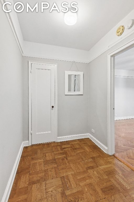 spare room with dark parquet flooring