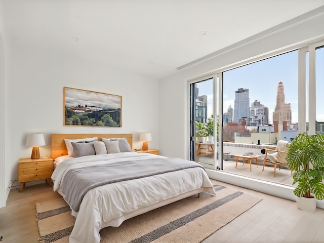 bedroom featuring light hardwood / wood-style floors and access to outside