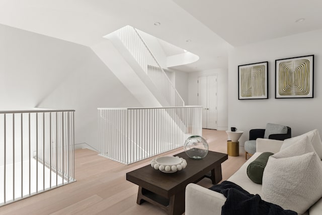 living room with lofted ceiling and light hardwood / wood-style flooring