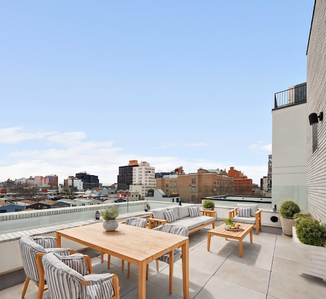 view of patio featuring an outdoor hangout area and a balcony