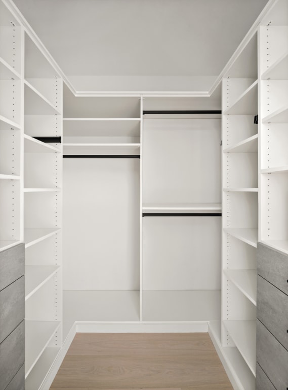 walk in closet with wood-type flooring