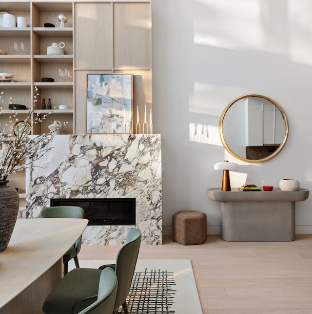 living room featuring light wood-type flooring and a premium fireplace