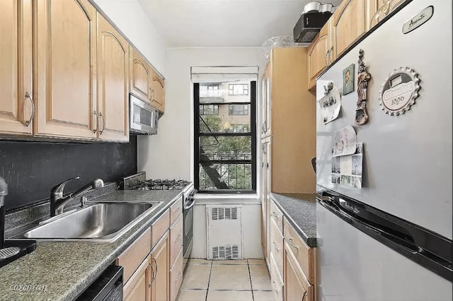 kitchen with light tile patterned floors, light brown cabinetry, sink, and stainless steel appliances