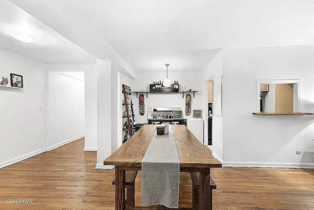 dining space with wood-type flooring