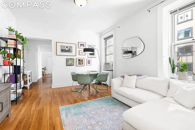 living room with cooling unit and light hardwood / wood-style floors