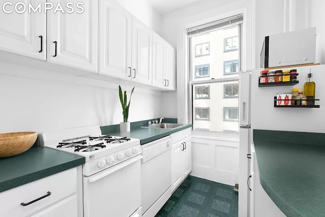 kitchen with white appliances, sink, and white cabinets