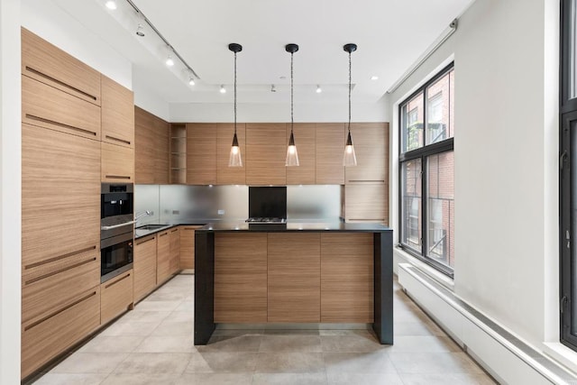 kitchen with a baseboard heating unit, a kitchen island, light tile patterned flooring, sink, and hanging light fixtures