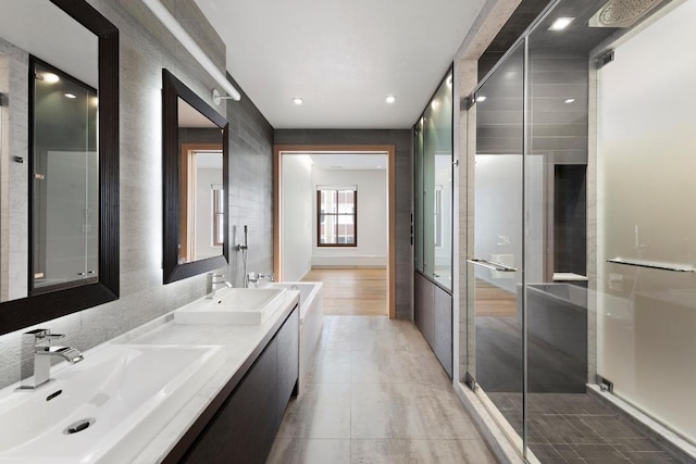 bathroom with vanity and a shower with door