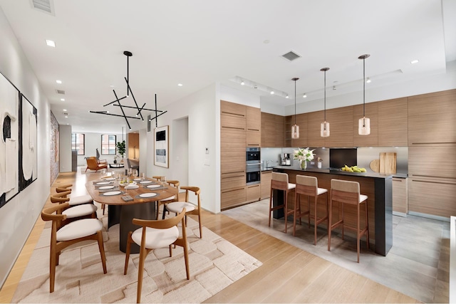 dining area with a chandelier, visible vents, recessed lighting, and light wood finished floors