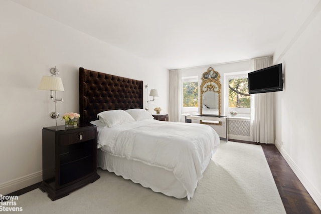 bedroom featuring dark parquet flooring