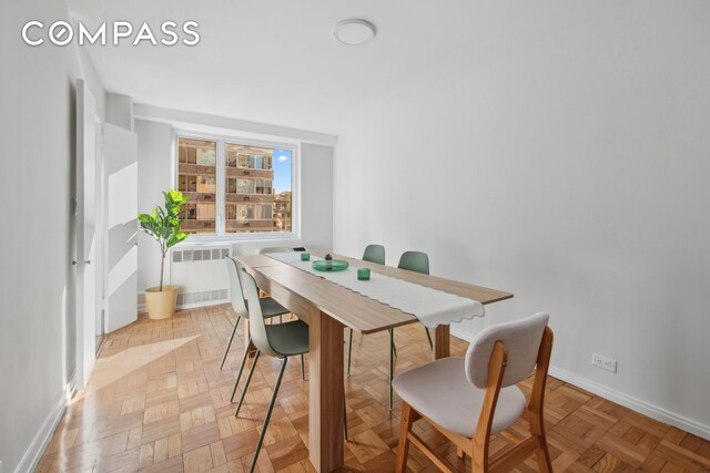 dining space with light parquet flooring