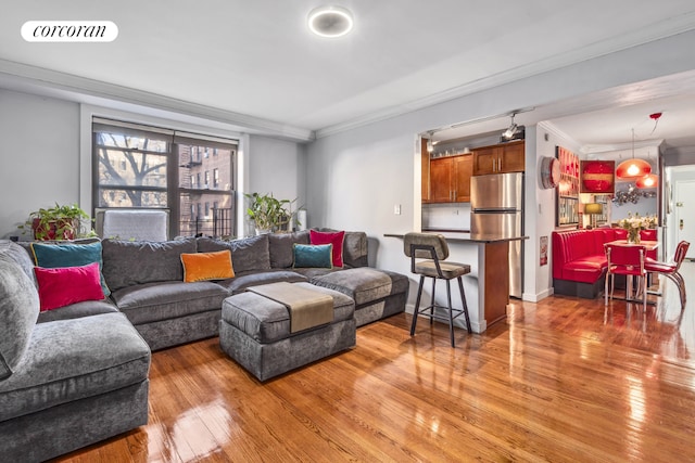 living room featuring ornamental molding and hardwood / wood-style flooring