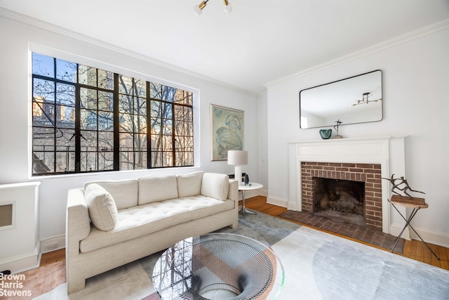 living room with a fireplace, ornamental molding, and hardwood / wood-style floors