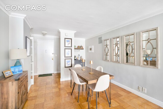 dining room with light parquet flooring and ornamental molding