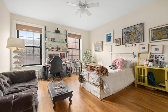 bedroom with ceiling fan and wood-type flooring