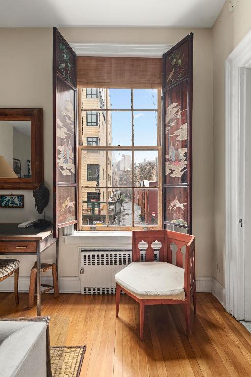 living area featuring radiator and hardwood / wood-style floors