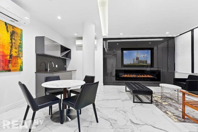 dining room with an AC wall unit and sink