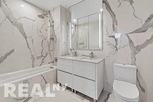 full bathroom with toilet, vanity, and shower / bathing tub combination