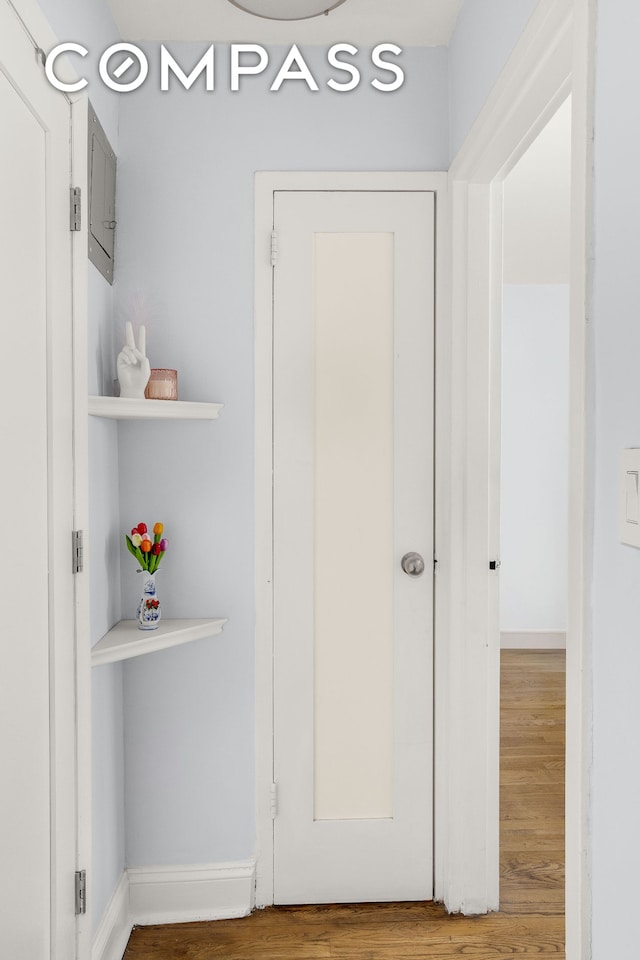 interior space with baseboards and wood finished floors