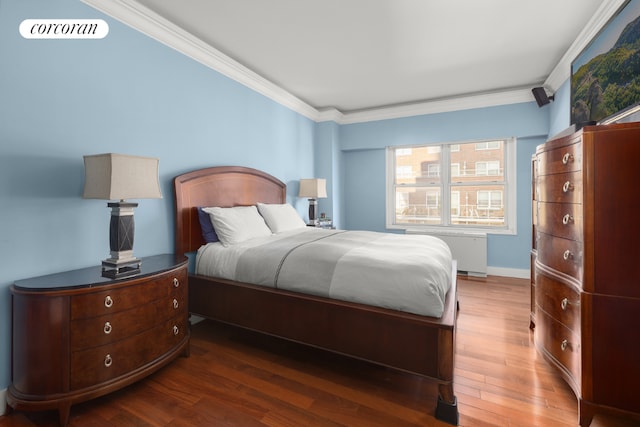 bedroom featuring dark wood-type flooring, radiator heating unit, and ornamental molding