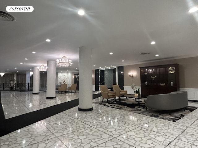 common area featuring crown molding, a wainscoted wall, recessed lighting, and a decorative wall