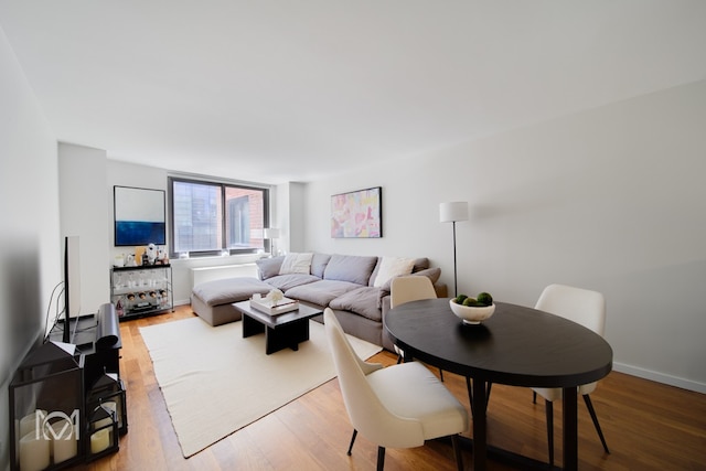 living room featuring baseboards and wood finished floors