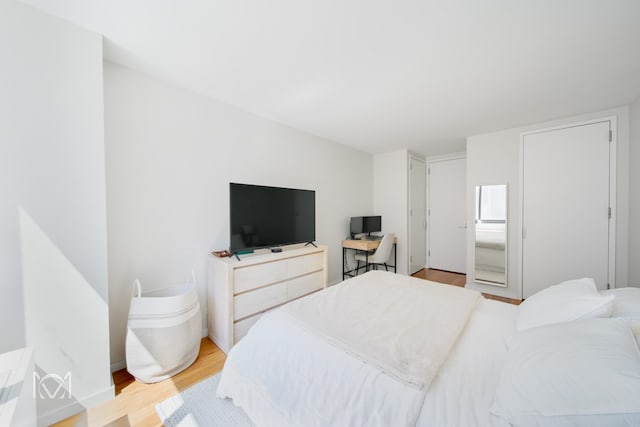 bedroom featuring light wood-style floors