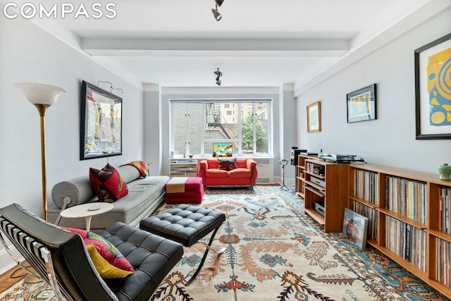 sitting room featuring crown molding and beamed ceiling