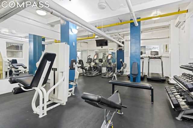 gym featuring an AC wall unit