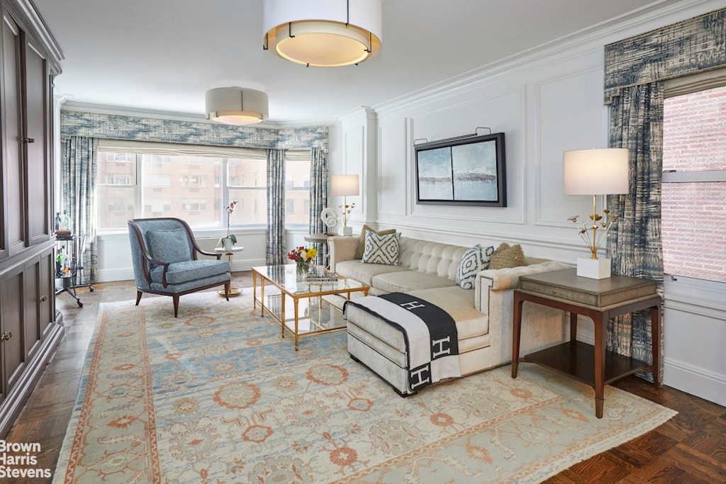 20 Sutton Pl S Unit 5A, New York City, NY 10022 - living room featuring ornamental molding and a decorative wall