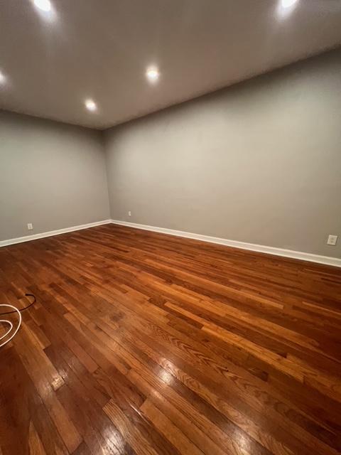 1241 E 98th St, New York City, NY 11236 - spare room featuring dark wood-type flooring, baseboards, and recessed lighting