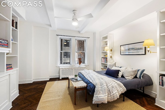 bedroom featuring ceiling fan, dark parquet flooring, radiator heating unit, and beam ceiling