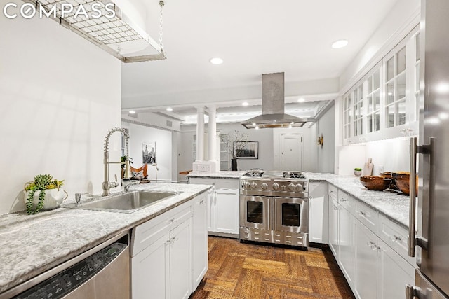 kitchen featuring dark parquet flooring, sink, island exhaust hood, white cabinetry, and appliances with stainless steel finishes