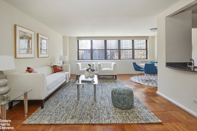 living room featuring sink and parquet flooring