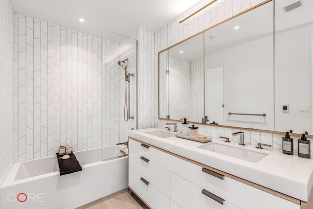 bathroom with tiled shower / bath and vanity