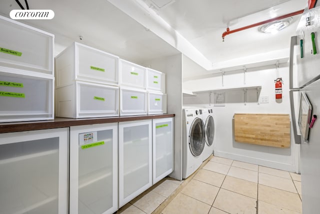 washroom with light tile patterned floors and independent washer and dryer