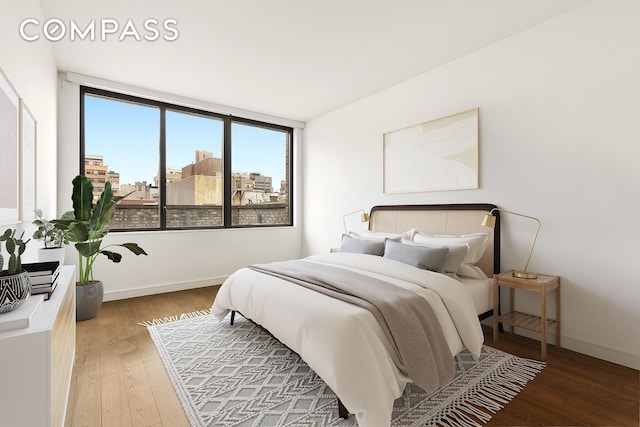 bedroom with light wood-style floors and baseboards