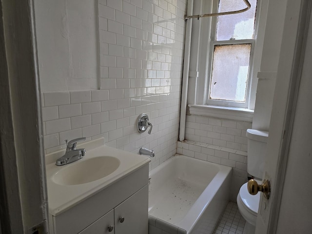 924 Summit Ave Unit 1B, New York City, NY 10452 - bathroom featuring tile walls, toilet, vanity, and backsplash