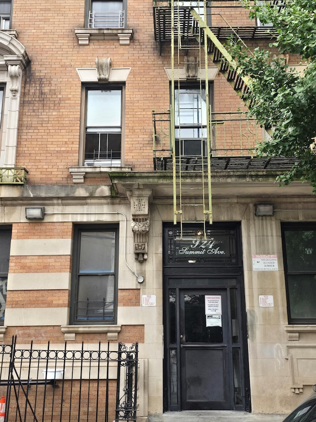 924 Summit Ave Unit 1B, New York City, NY 10452 - property entrance featuring brick siding and fence