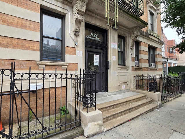 924 Summit Ave Unit 1B, New York City, NY 10452 - view of exterior entry with fence, brick siding, and stone siding
