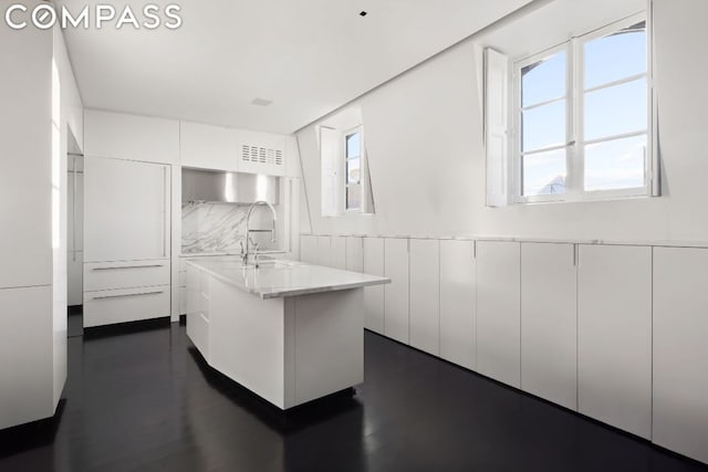 kitchen with sink, white cabinets, and tasteful backsplash