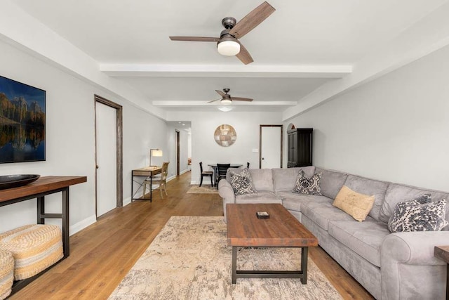 living room featuring beam ceiling, dark parquet flooring, a wealth of natural light, and an inviting chandelier