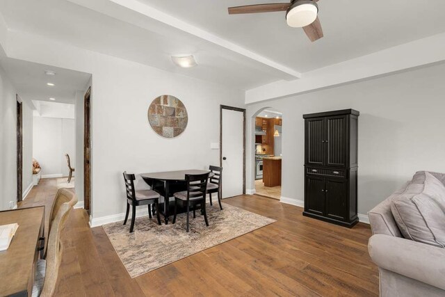 living room featuring beamed ceiling and dark parquet floors