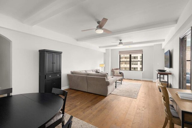 bedroom with wood-type flooring and beam ceiling