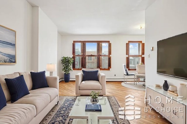 living room featuring a baseboard heating unit and light hardwood / wood-style flooring