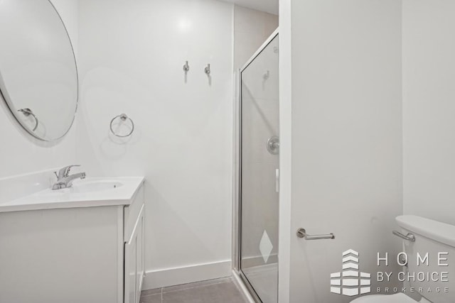 bathroom with toilet, walk in shower, vanity, and tile patterned flooring