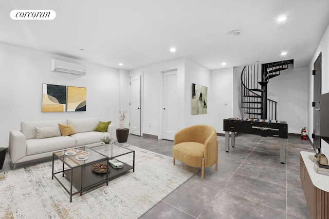 living room featuring a wall mounted AC and concrete flooring