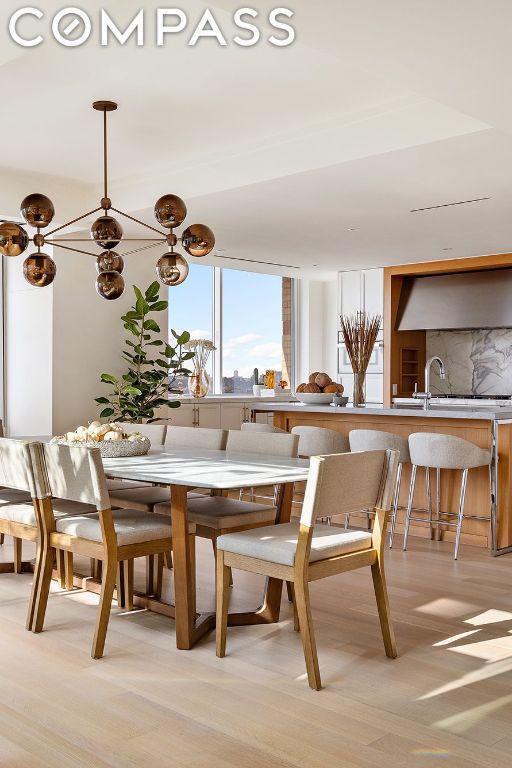 dining room featuring light wood-type flooring and sink