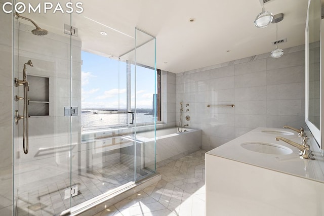 bathroom with vanity, tile walls, and independent shower and bath