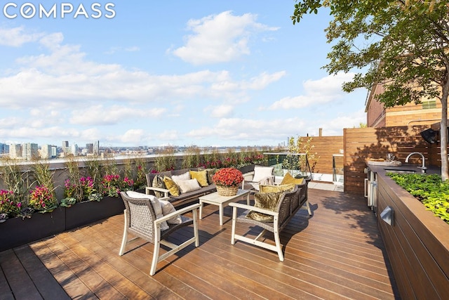 deck featuring an outdoor living space and sink